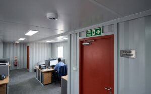 Fire safety exit and smoke detection inside a containerized block office