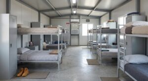 Furnished dormitory interior of a labour accommodation cabin with bunk beds and lockers