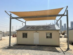 Shade netting installed above an insulated site office cabin roof in Dubai
